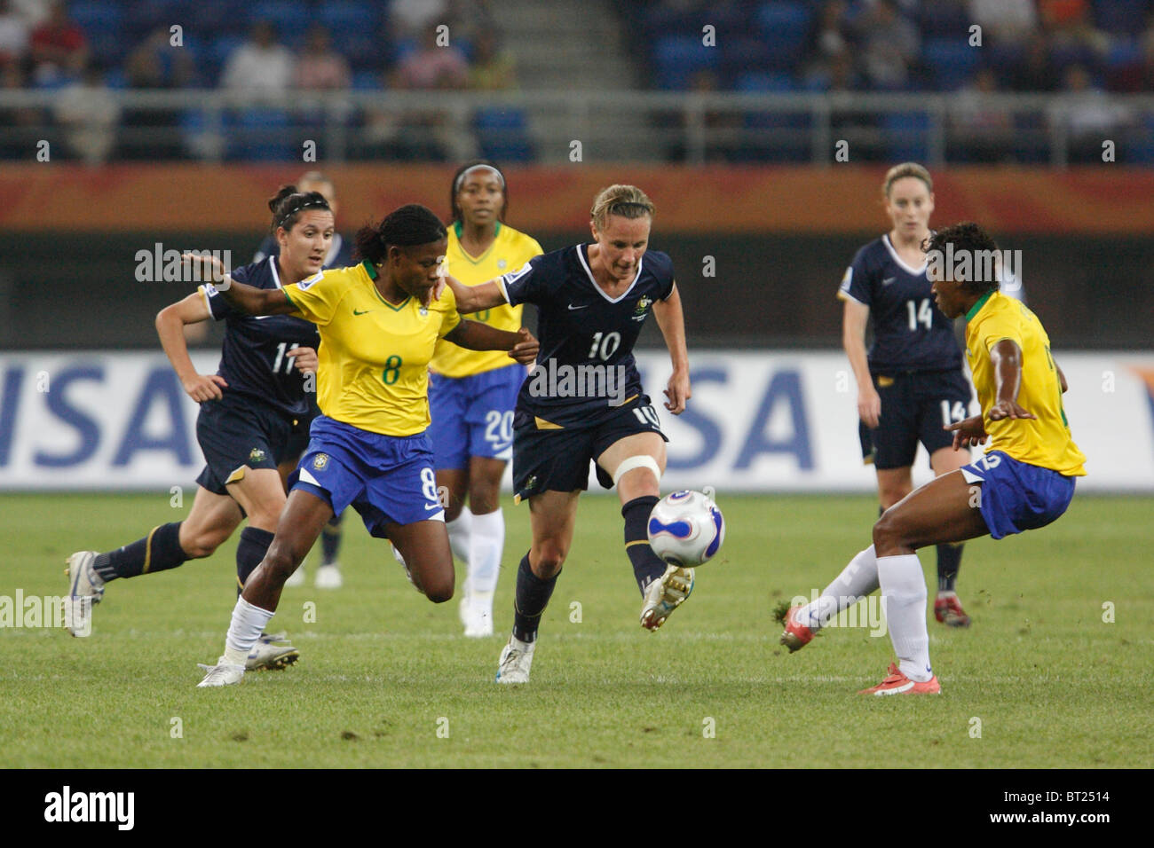 Joanne Peters of Australia (10) kicks the ball as Formiga of Brazil (8) defends during a 2007 Women's World Cup match. Stock Photo