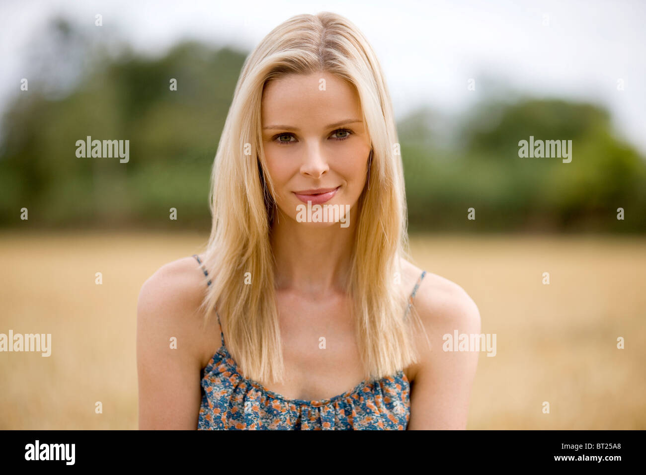 A portrait of a blonde haired woman in a wheatfield Stock Photo
