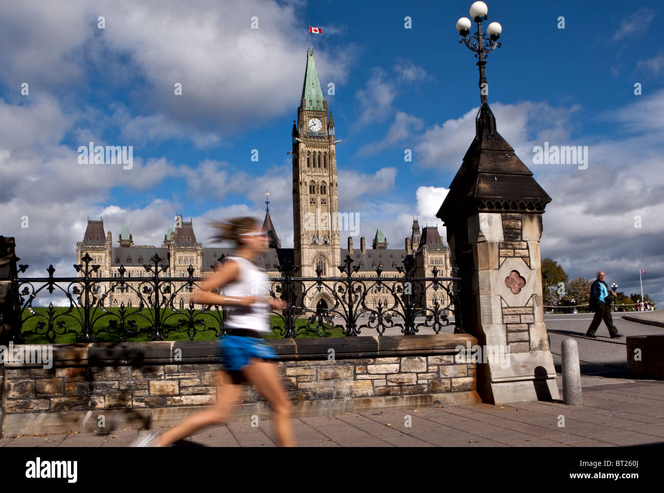 A woman runs by the Parliament in Ottawa Monday September 27, 2010 Stock Photo