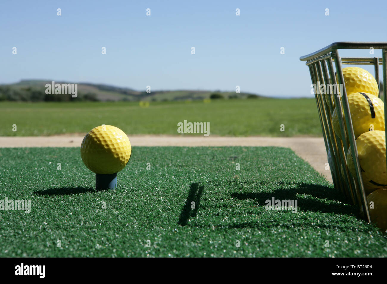 Golf ball and bucket at driving range Stock Photo Alamy