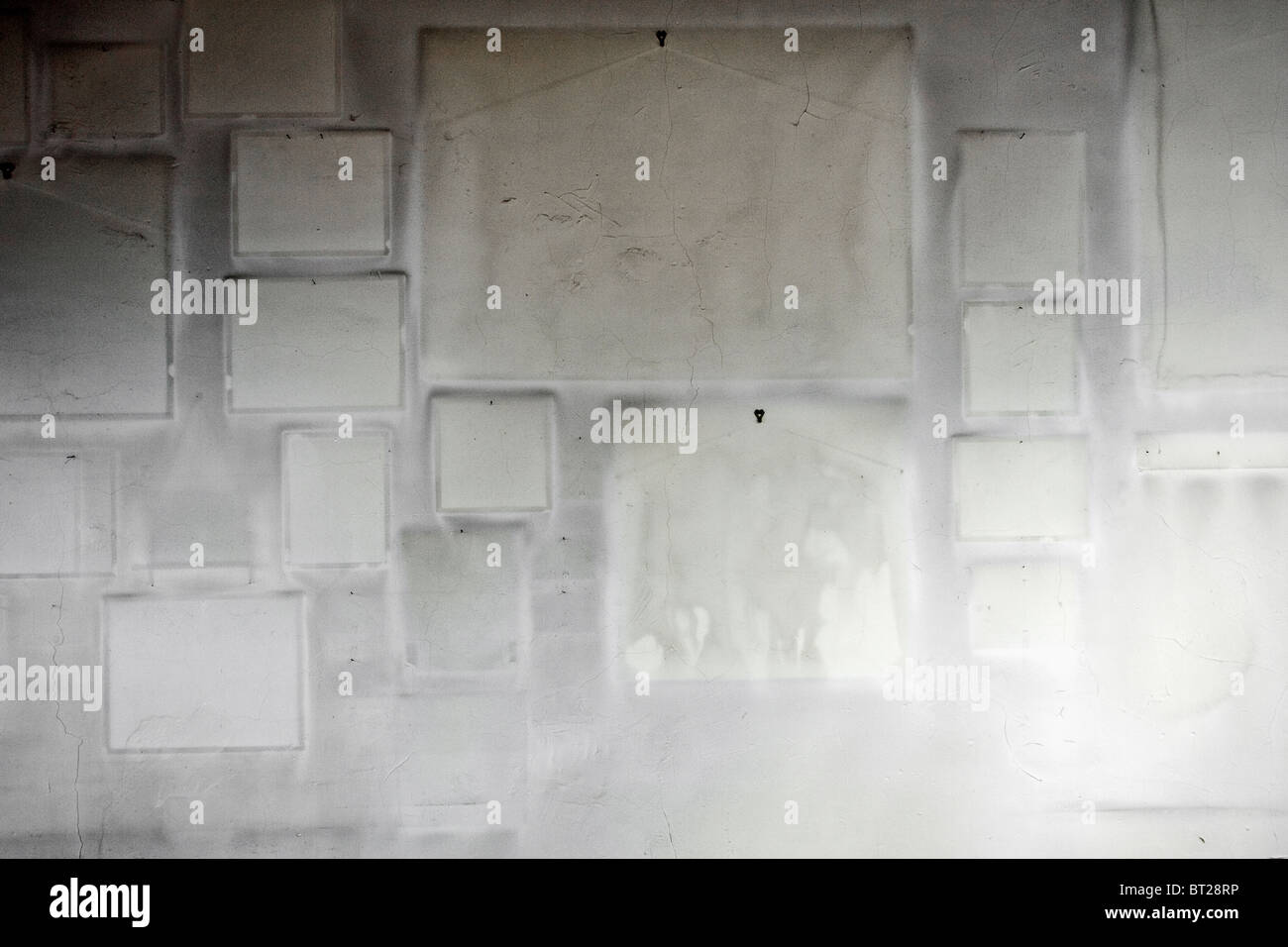 White wall void of hanging art with frame imprints left behind Stock