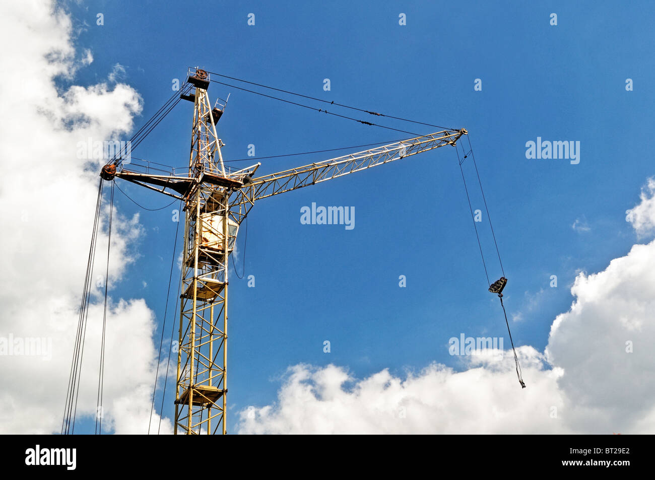 Old rusty rail crane standing upon blue sky Stock Photo