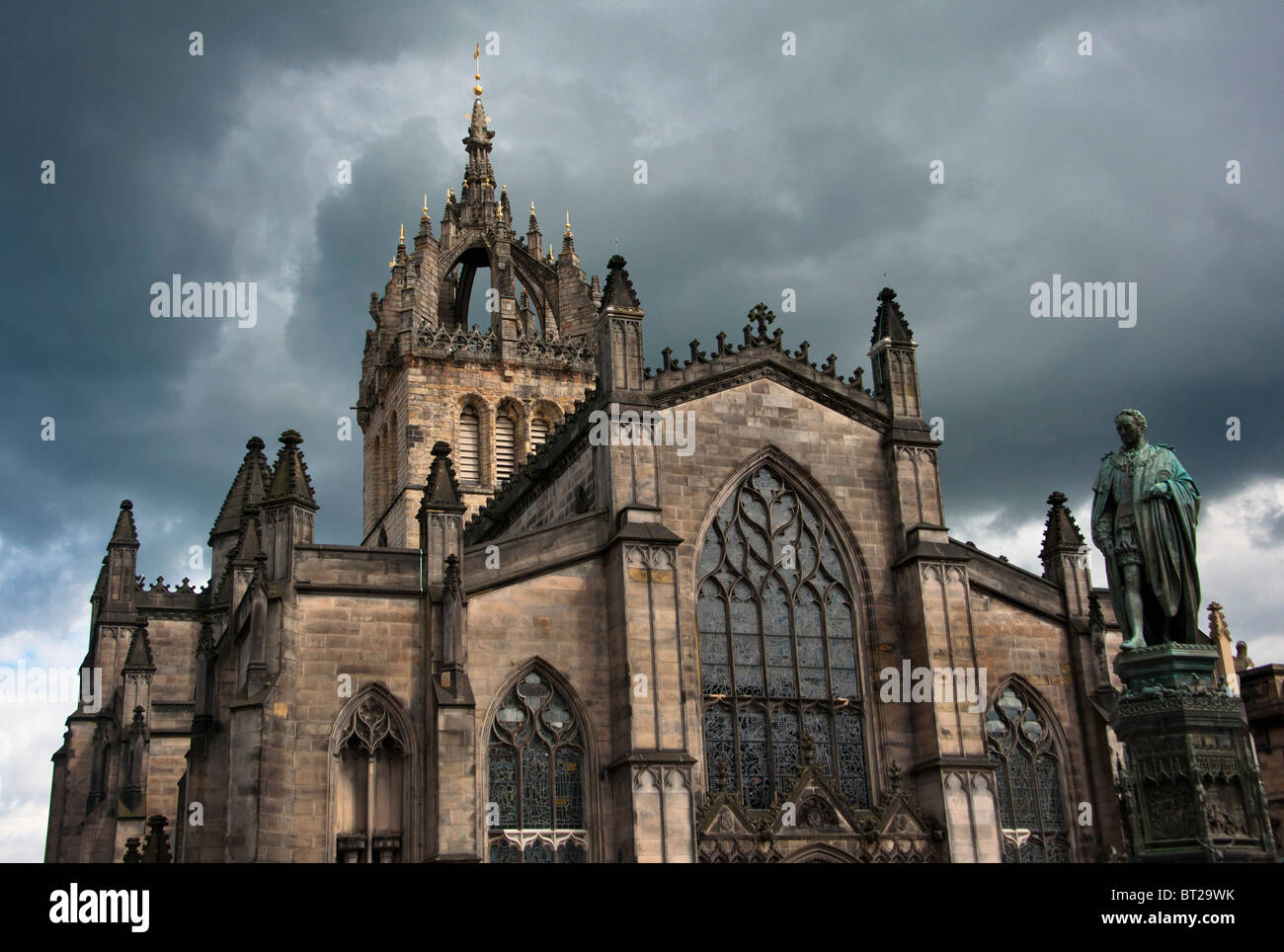 St Giles Cathedral under a stormy sky with a statue of economist  Adam Smith , Royal Mile, Edinburgh, Scotland. Stock Photo