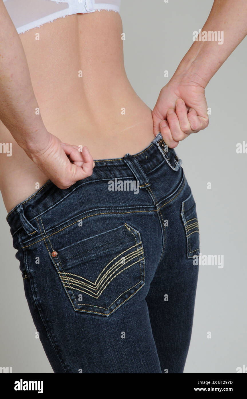 Woman putting on tight jeans hi res stock photography and images