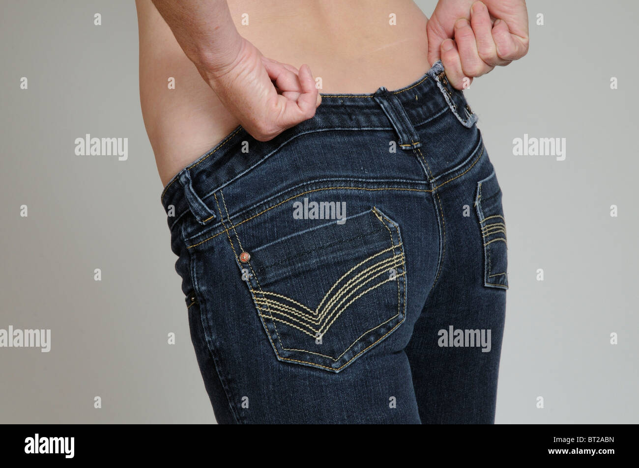 Pulling on tight jeans hires stock photography and images Alamy