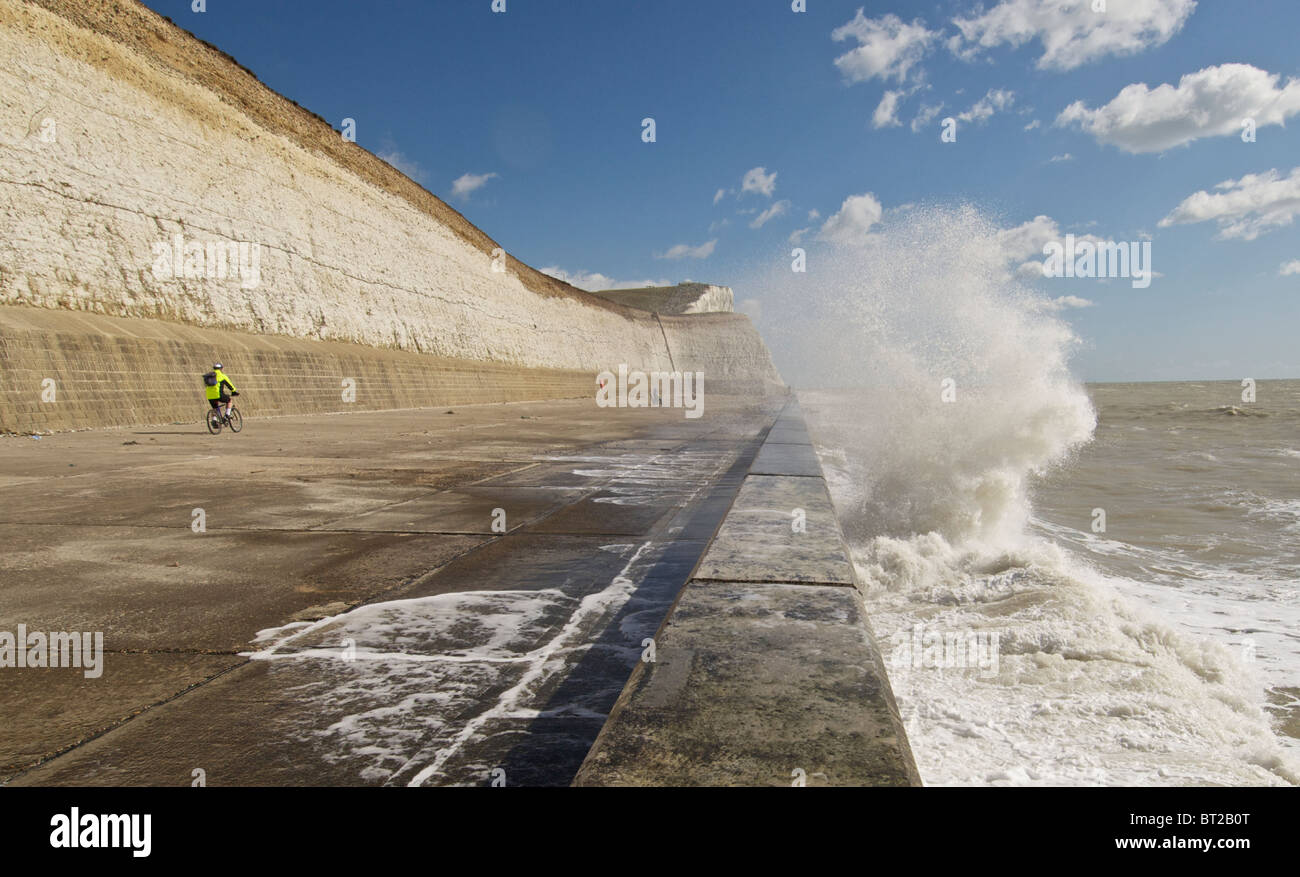 Waves crash on undercliff walk defence defense wall near Brighton Stock Photo
