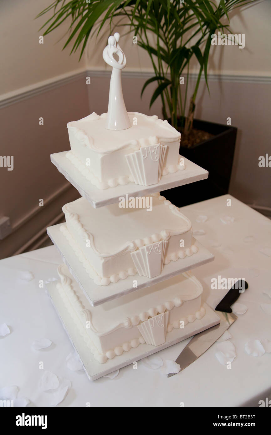 A three tiered wedding cake on display at a wedding reception. The cake is styled in the 1930's Art Deco style. Stock Photo