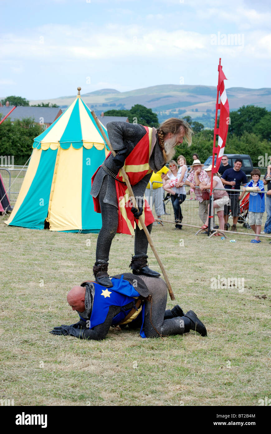 Knight in Armour on an opponents back at an re-enactment event Stock Photo