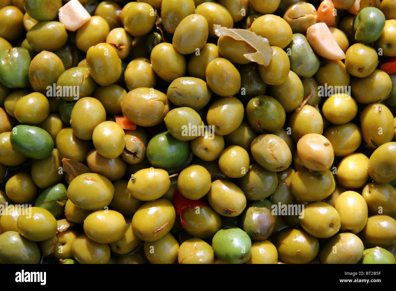 olives in pickling brine pattern background texture in market Stock Photo