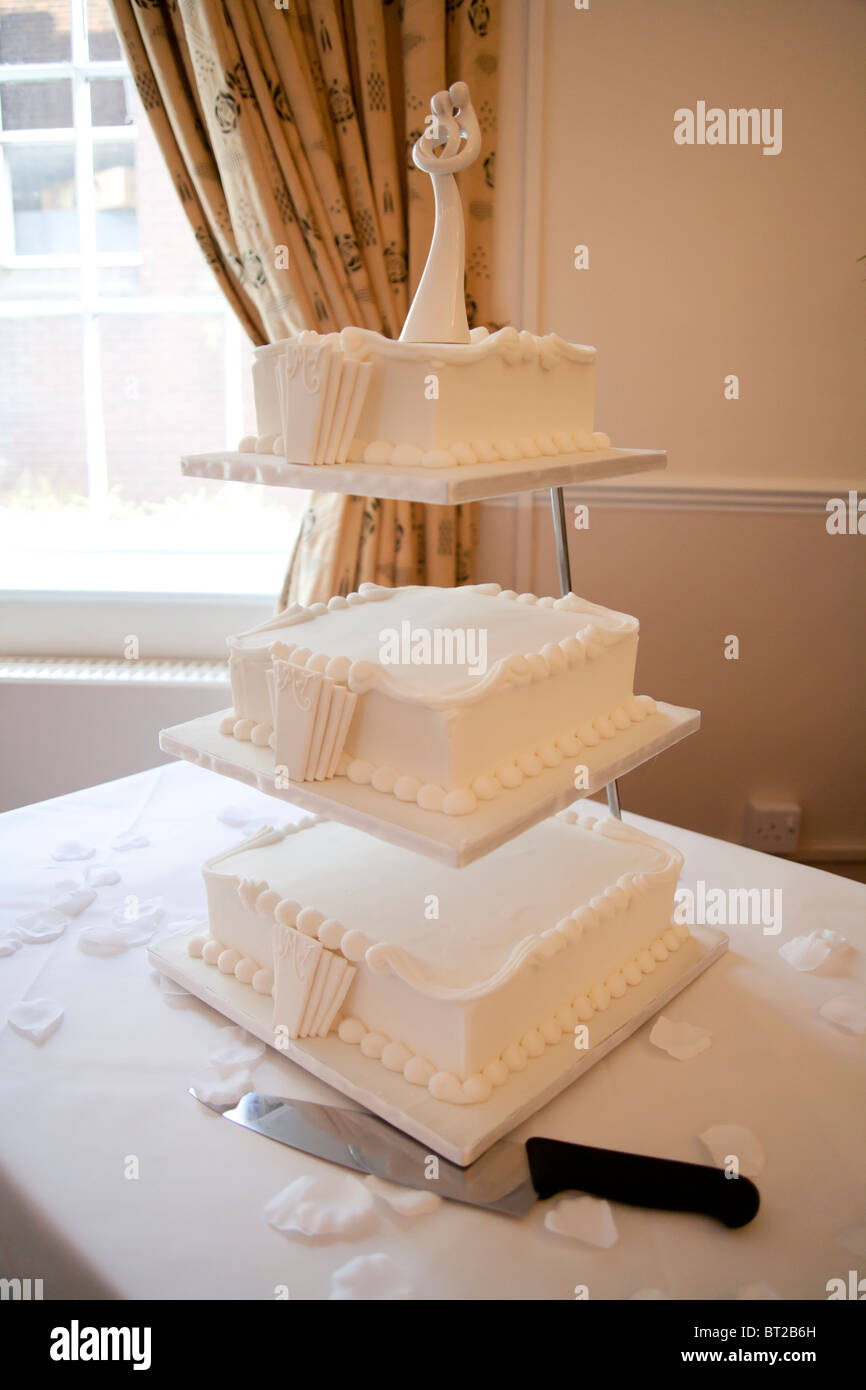 A three tiered wedding cake on display at a wedding reception. The cake is styled in the 1930's Art Deco style. Stock Photo