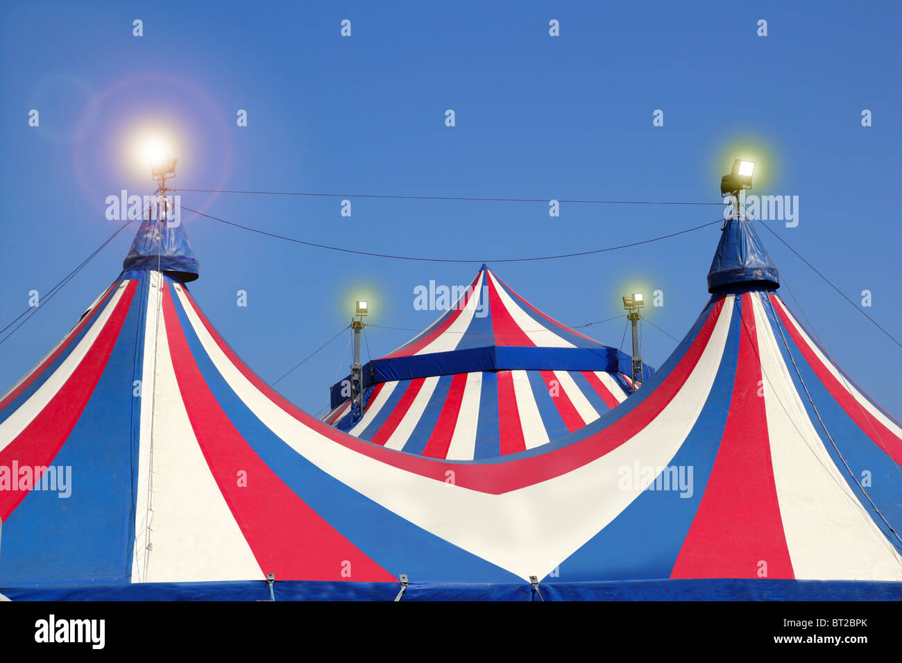 Circus tent under blue sky colorful stripes red white Stock Photo