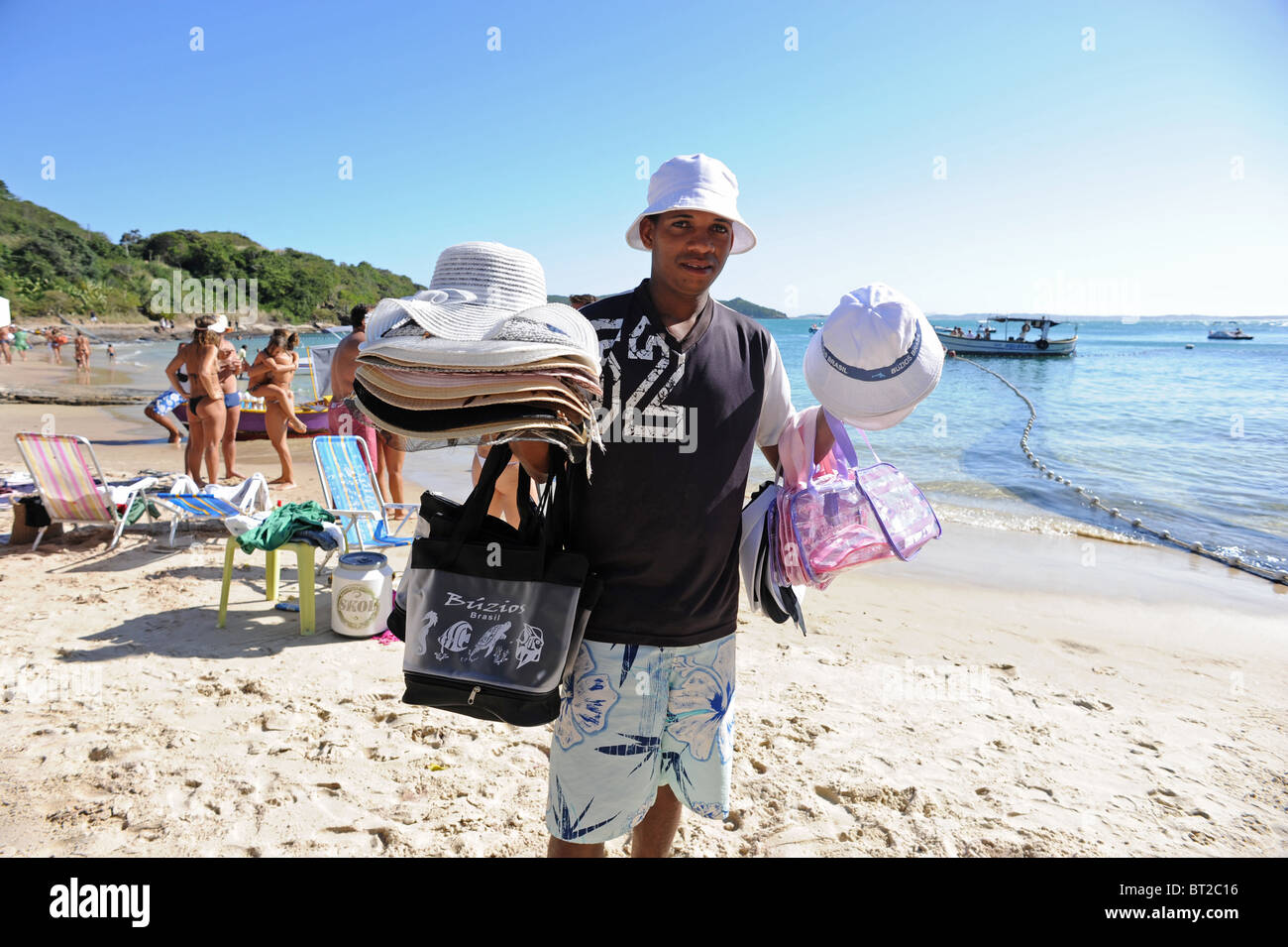 A beach vendor selling sun hats on Joao Fernandes Beach Buzios Stock Photo