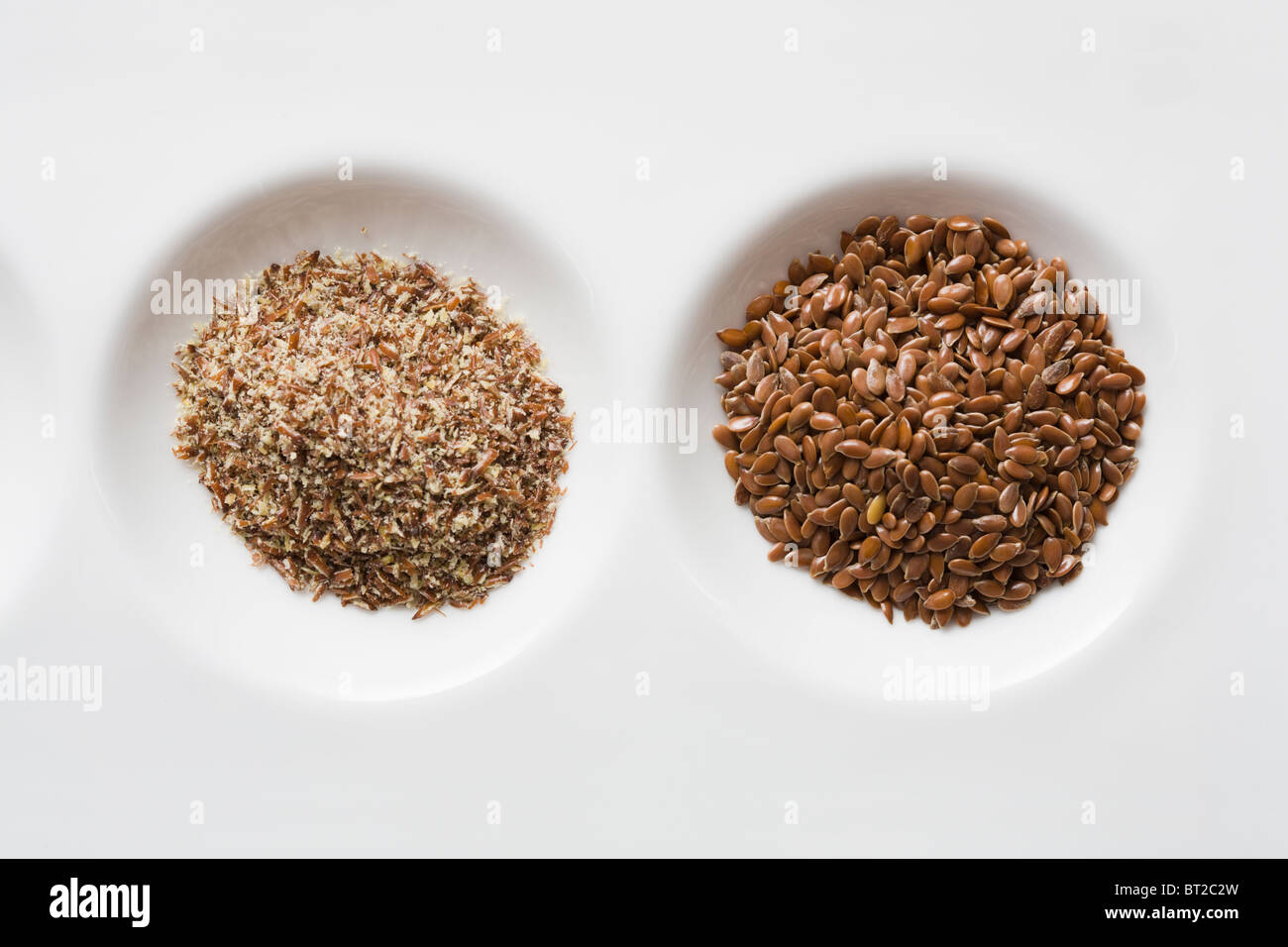 Whole flaxseeds and ground flaxseeds Stock Photo Alamy