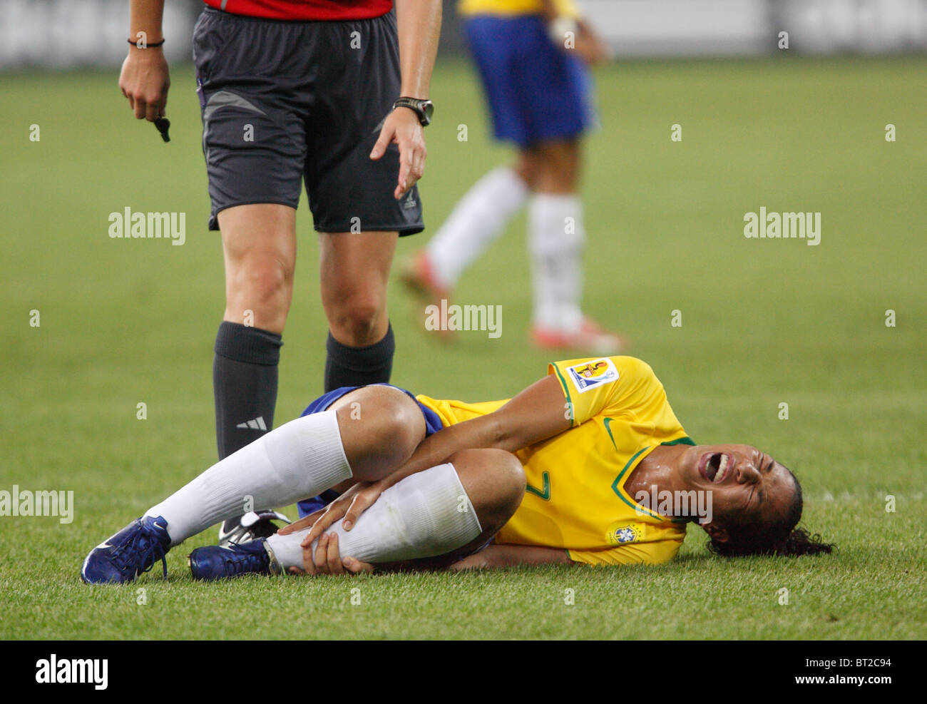 Daniela of Brazil grimaces after being injured during a 2007 Women's World Cup quarterfinal soccer match against Australia. Stock Photo