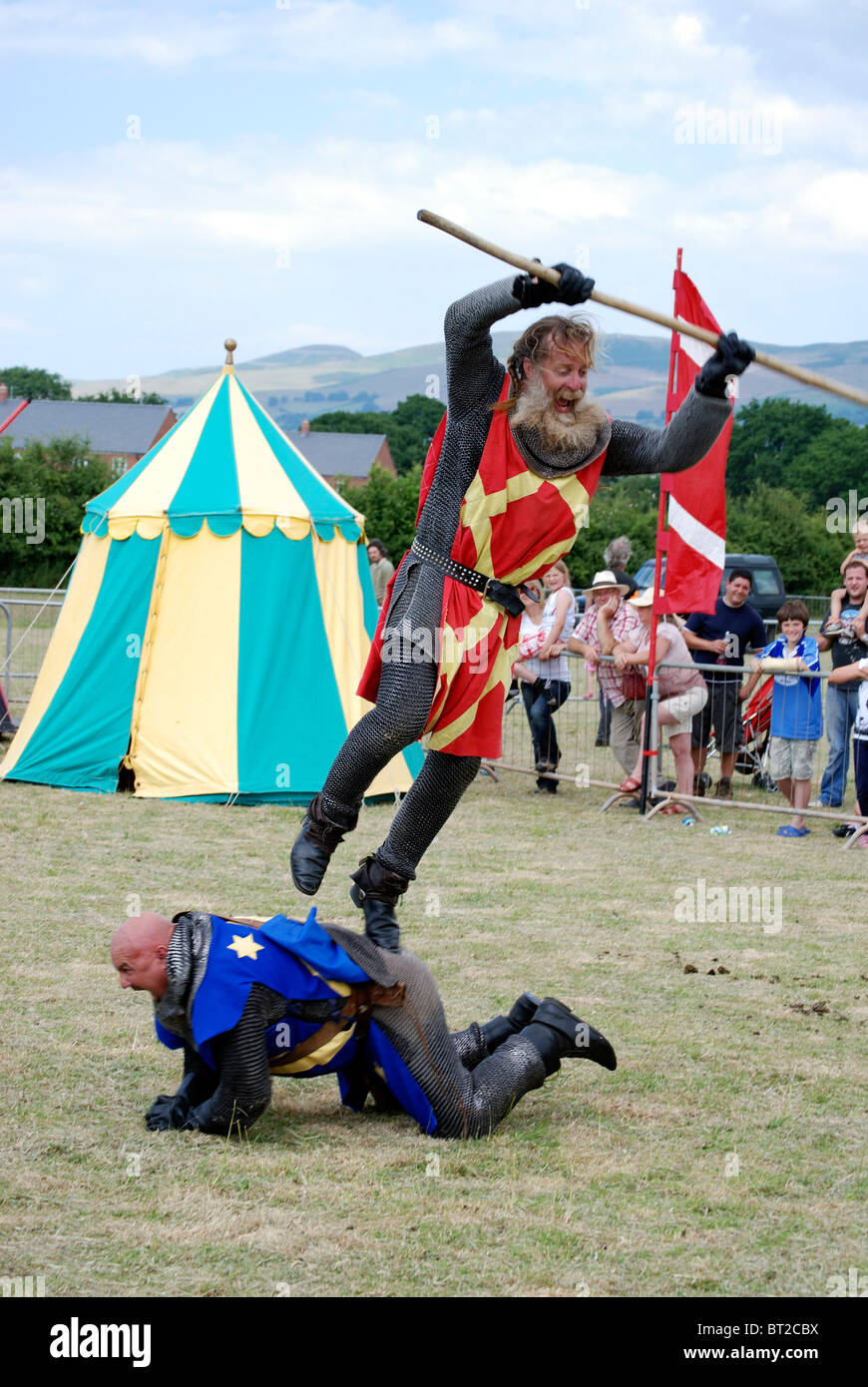 Knight in Armour jumping on an opponents back at a re-enactment event Stock Photo