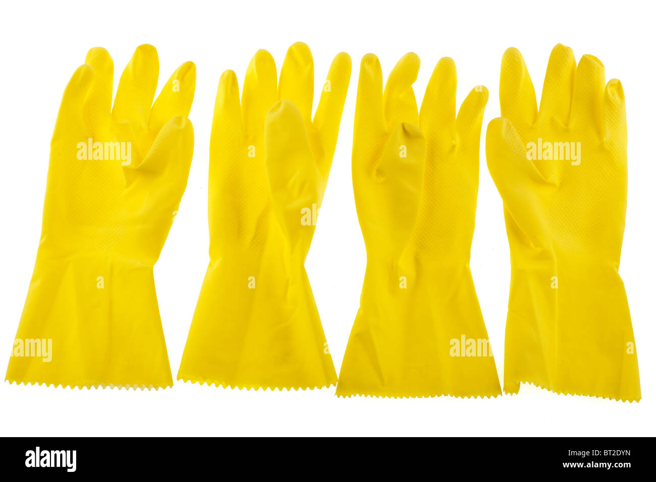 Two pairs of yellow medium sized household rubber gloves Stock Photo