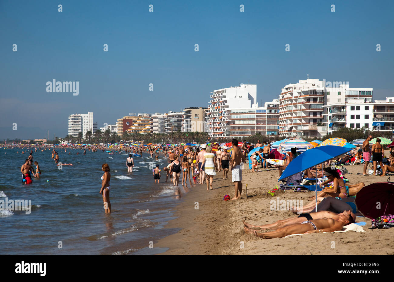 People sunbathing on Playa de Roses beach at Roses Emporda Catalunya Spain Stock Photo