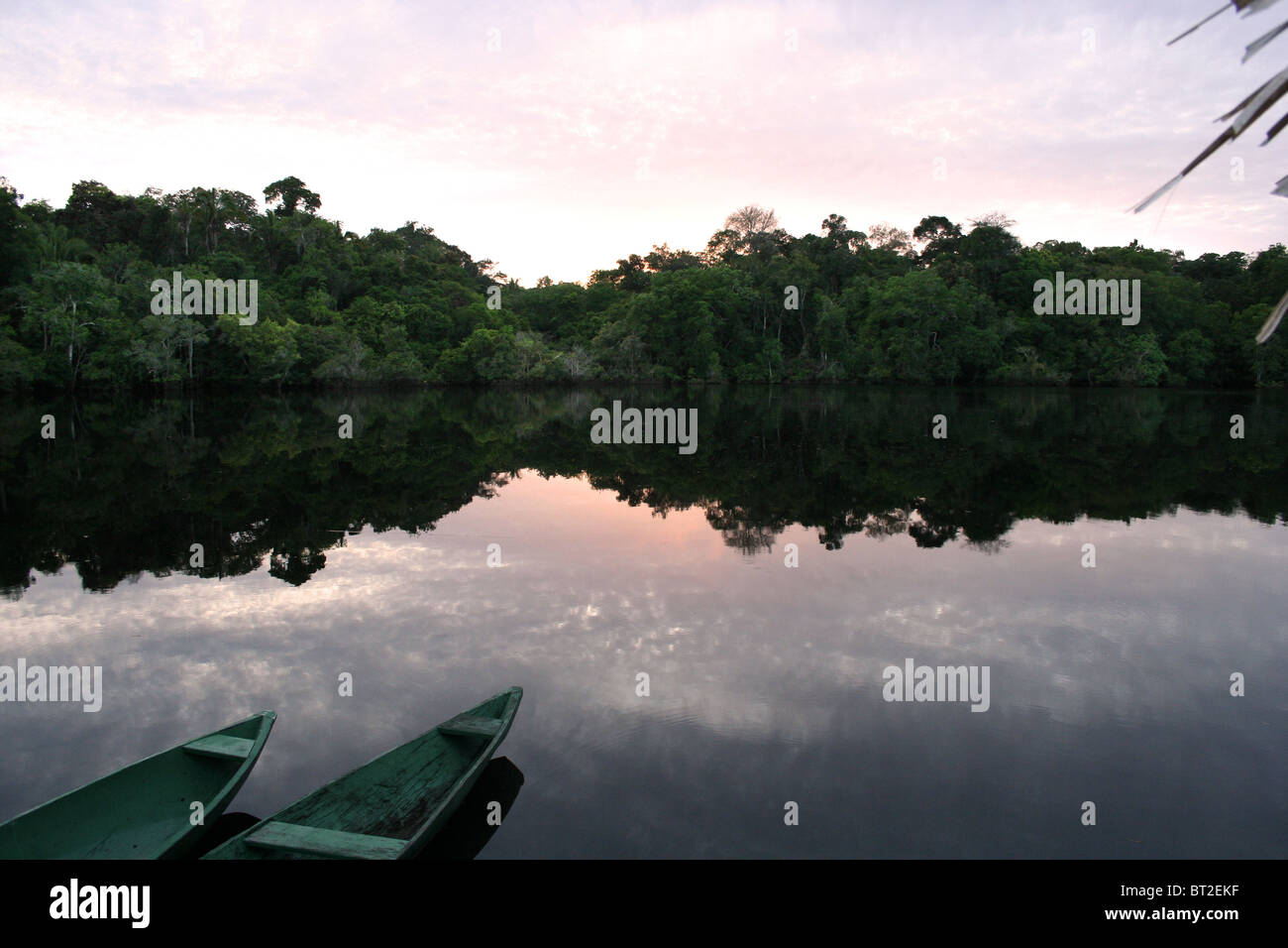 Canoes in Amazon sun rise Brazil Stock Photo