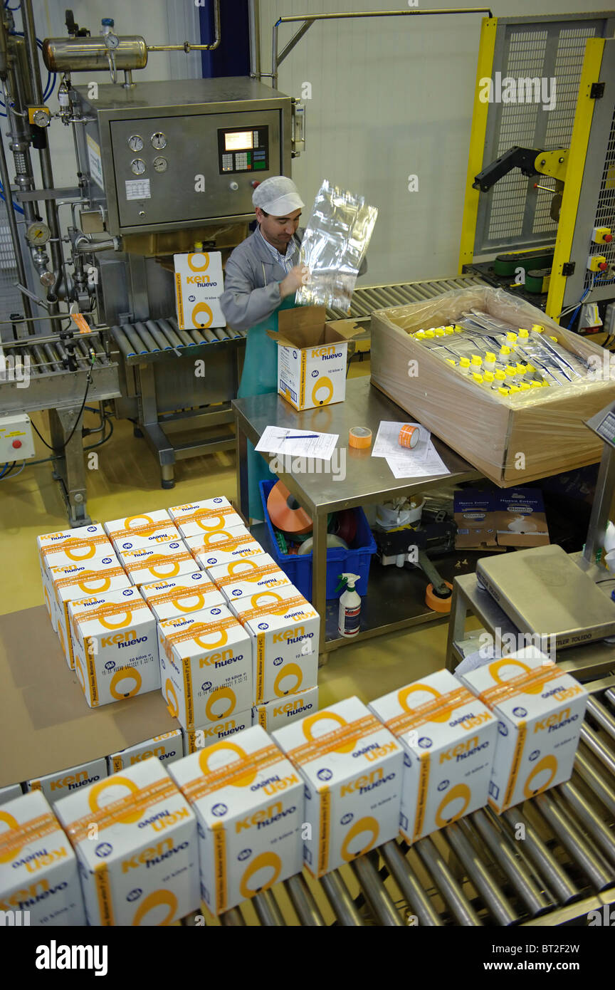 Male worker packing products at the production line of a factory Stock Photo