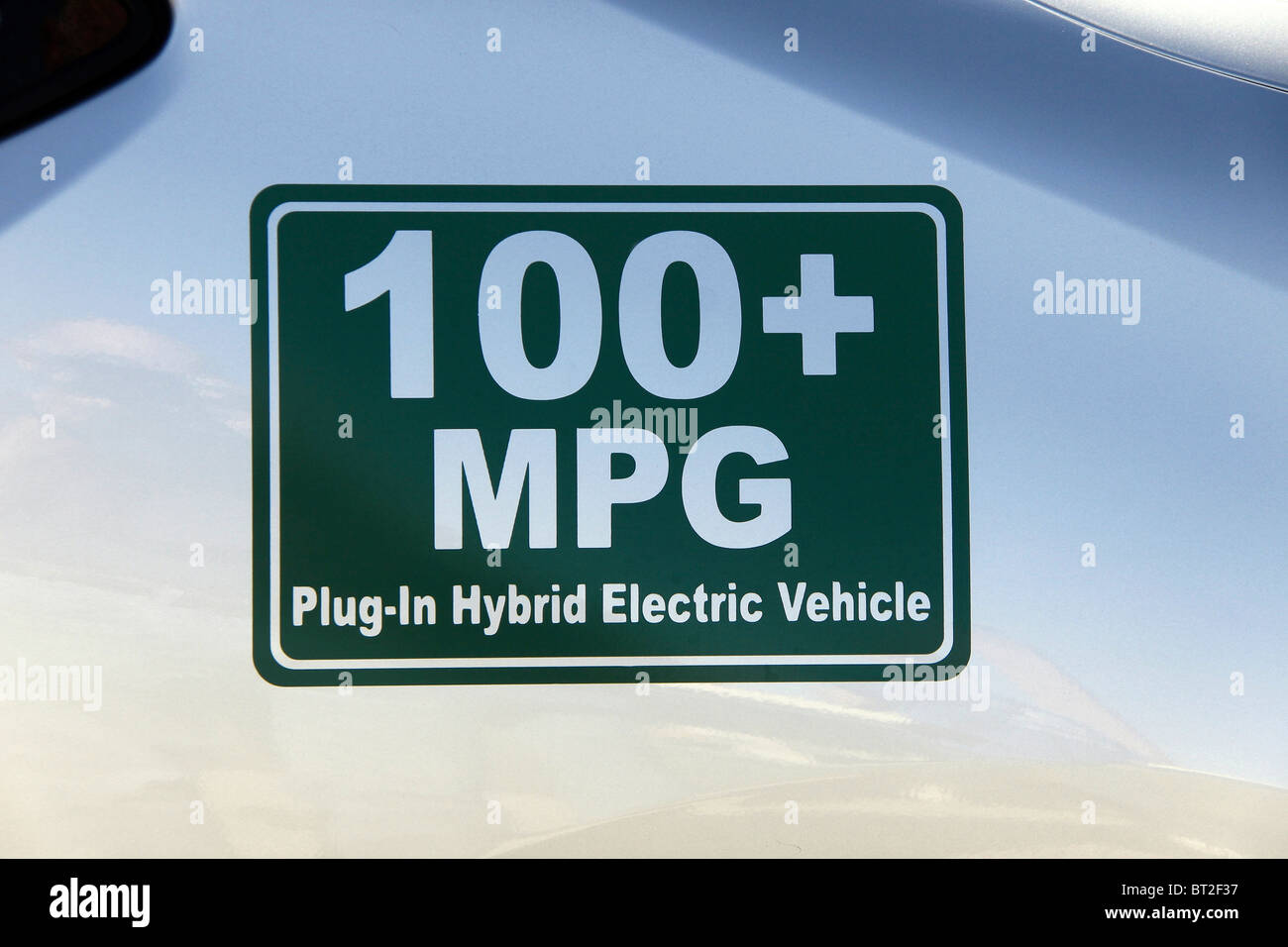 Close up stock photo of a symbol on a hybrid car on display promoting alternative transportation Stock Photo
