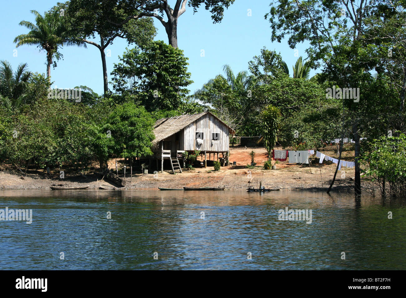 Wooden house by Amazon River, Brazil Stock Photo