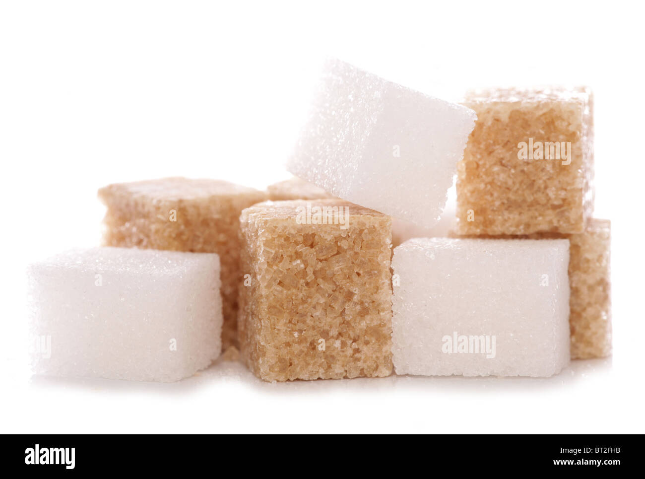Mixture of brown and white sugar cubes studio cutout Stock Photo