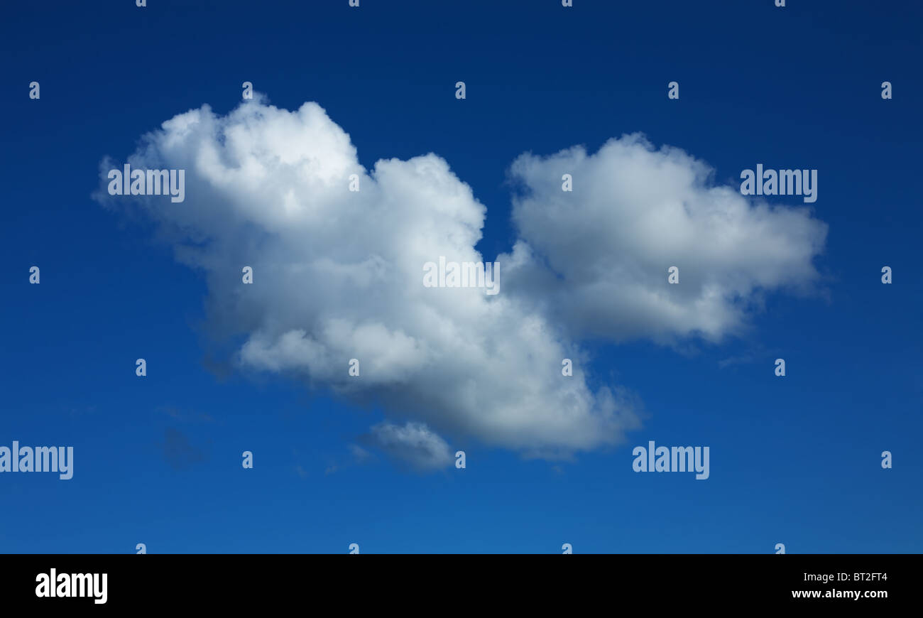 Lonely cloud of the unusual form in the dark blue sky Stock Photo