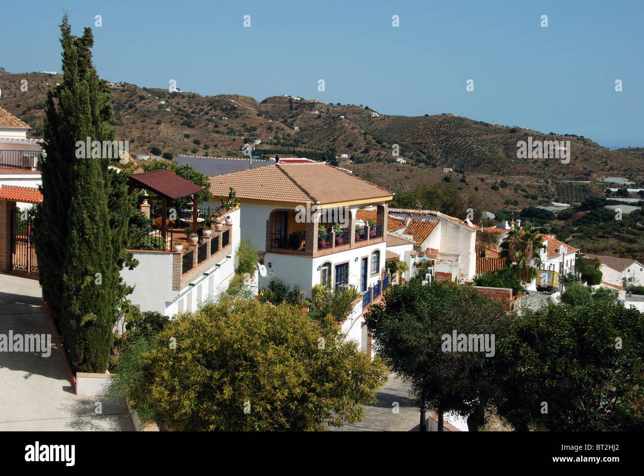 View over village rooftops, whitewashed village (pueblo blanco), Macharaviaya, Costa del Sol, Malaga Province, Andalucia, Spain. Stock Photo
