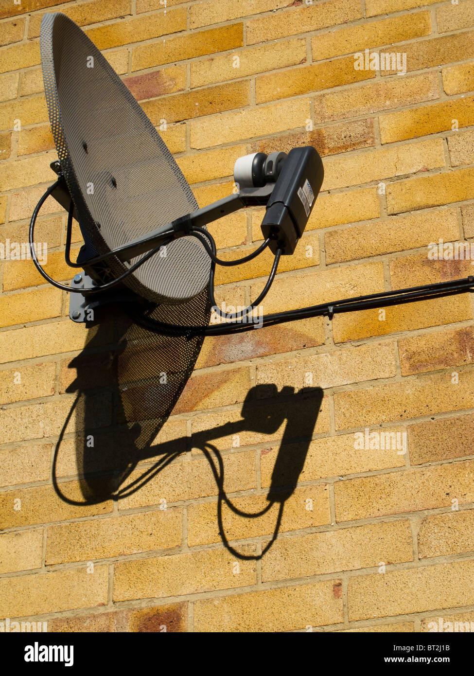 A BSkyB television satellite Ariel mounted on the wall of a house in the UK Stock Photo