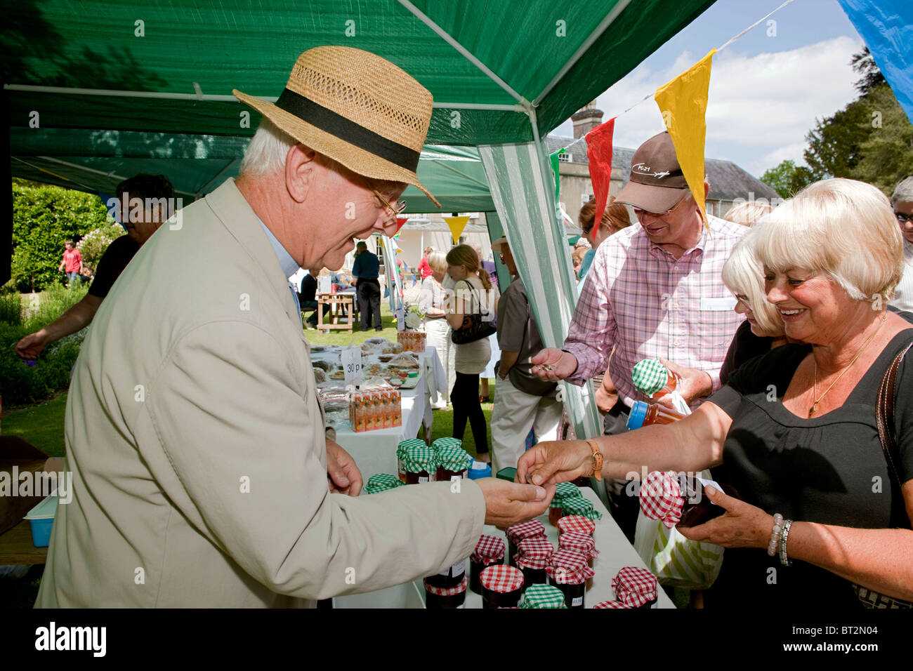 Curate Hugh Willis, selling his home made jars of jam at the annual