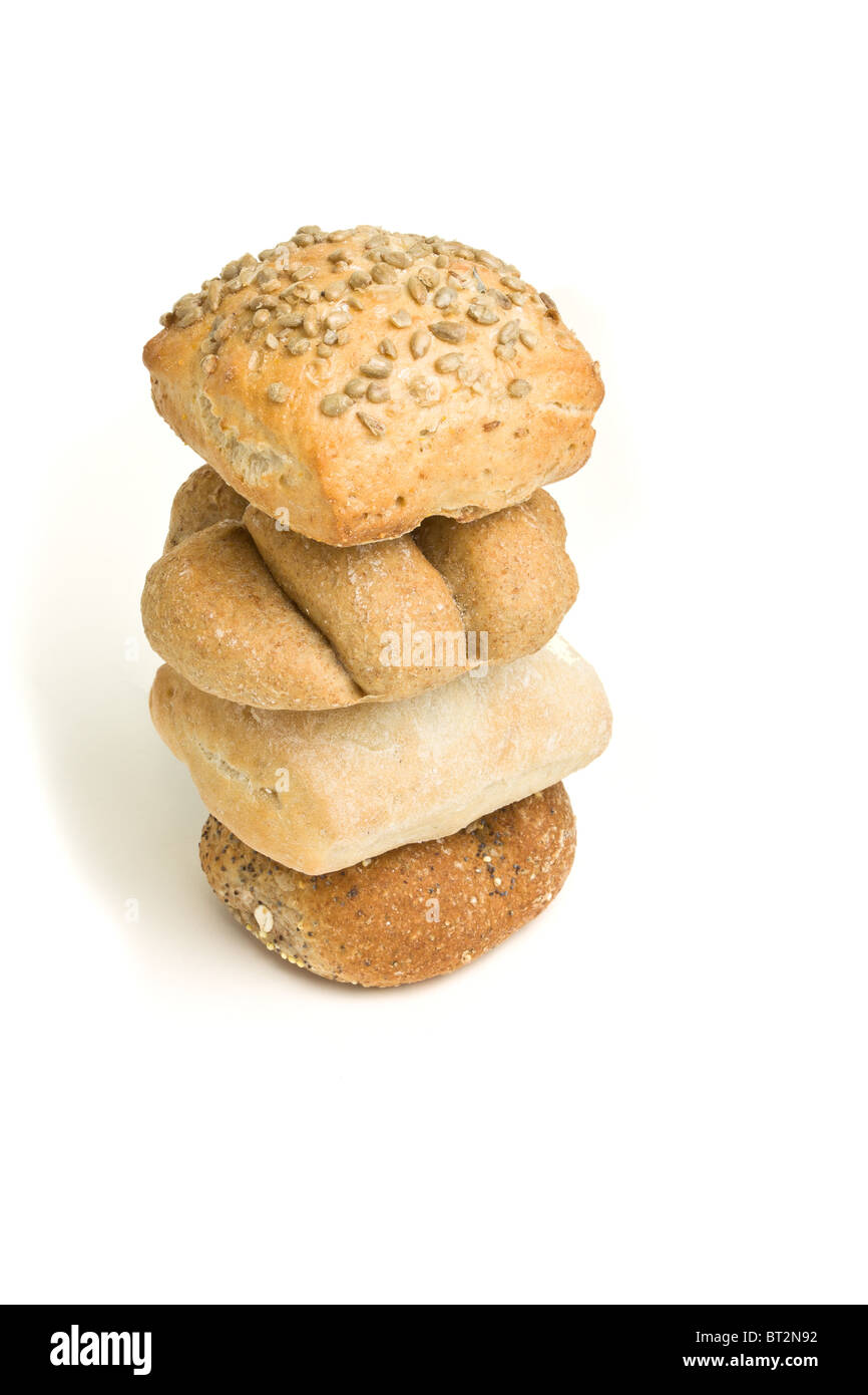 Abstract tower of handmade bread rolls from low perspective isolated against white. Stock Photo