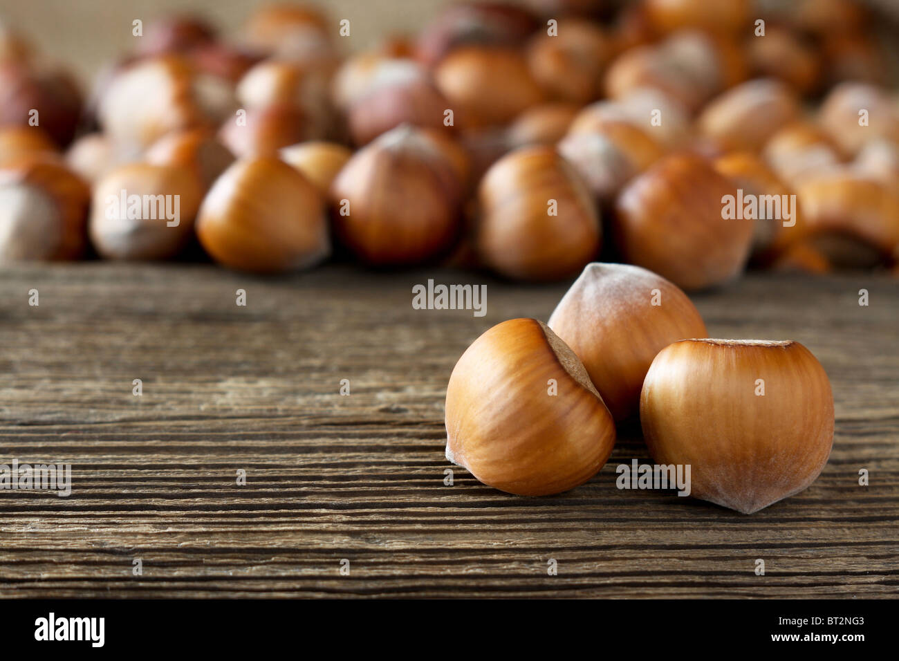 Ripe hazelnuts on wooden desk Stock Photo