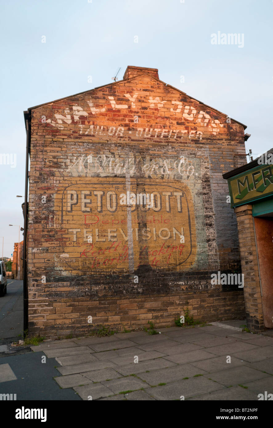Old shop sign painted on corner of house, Bradford Yorkshire Stock