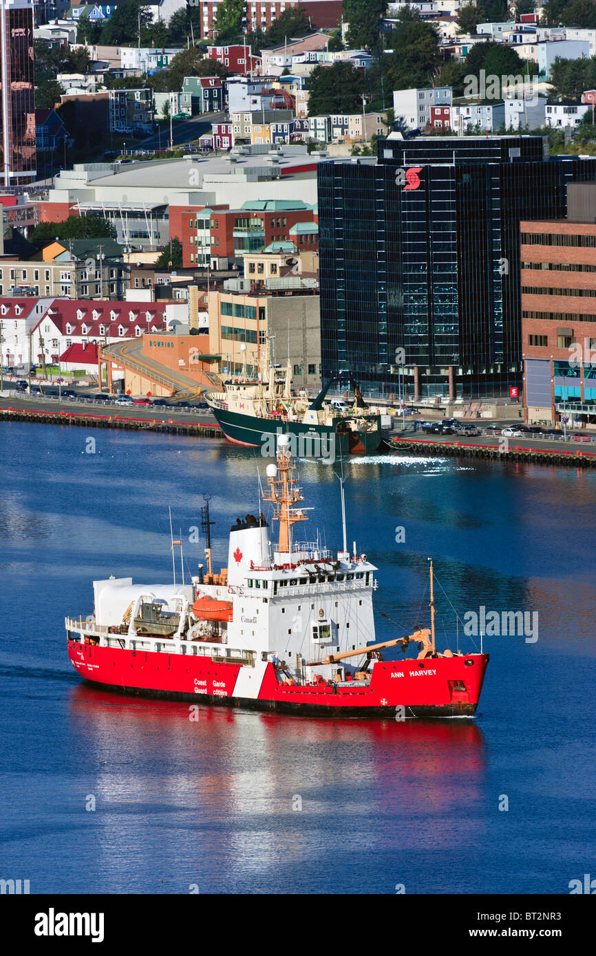 Offshore supply vessel Atlantic Eagle and Maersk Placentia leaving St Johns Newfoundland, with  cityscape in backgroundc Stock Photo