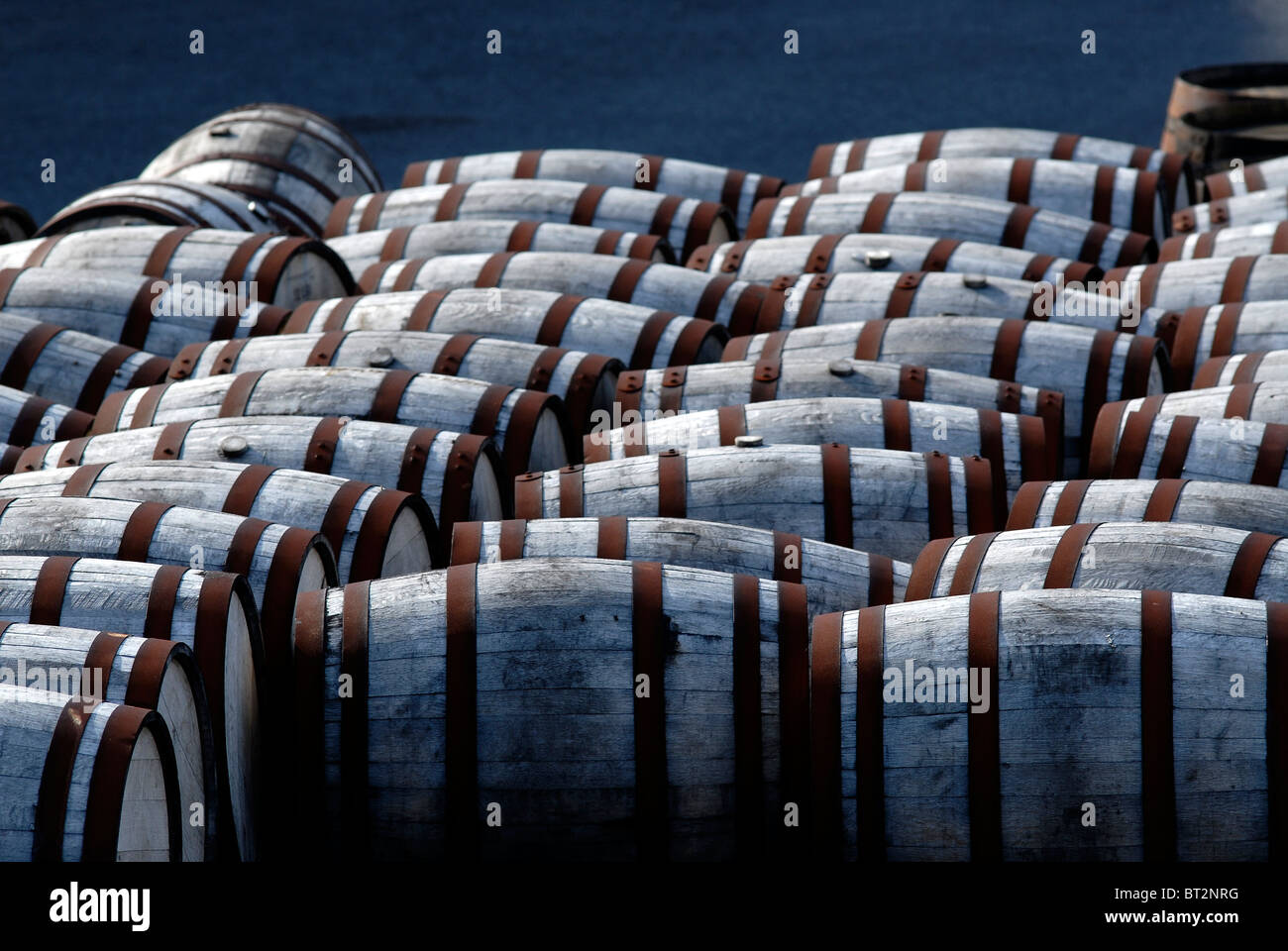 Barrels with rusted metal rings in a yard Stock Photo Alamy