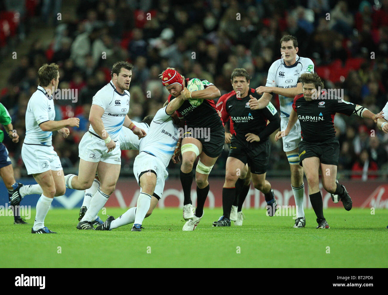 Mouritz Botha of Saracens is tackled by Leinster defense during the Heineken Cup Rugby match Saracens v Leinster. Stock Photo