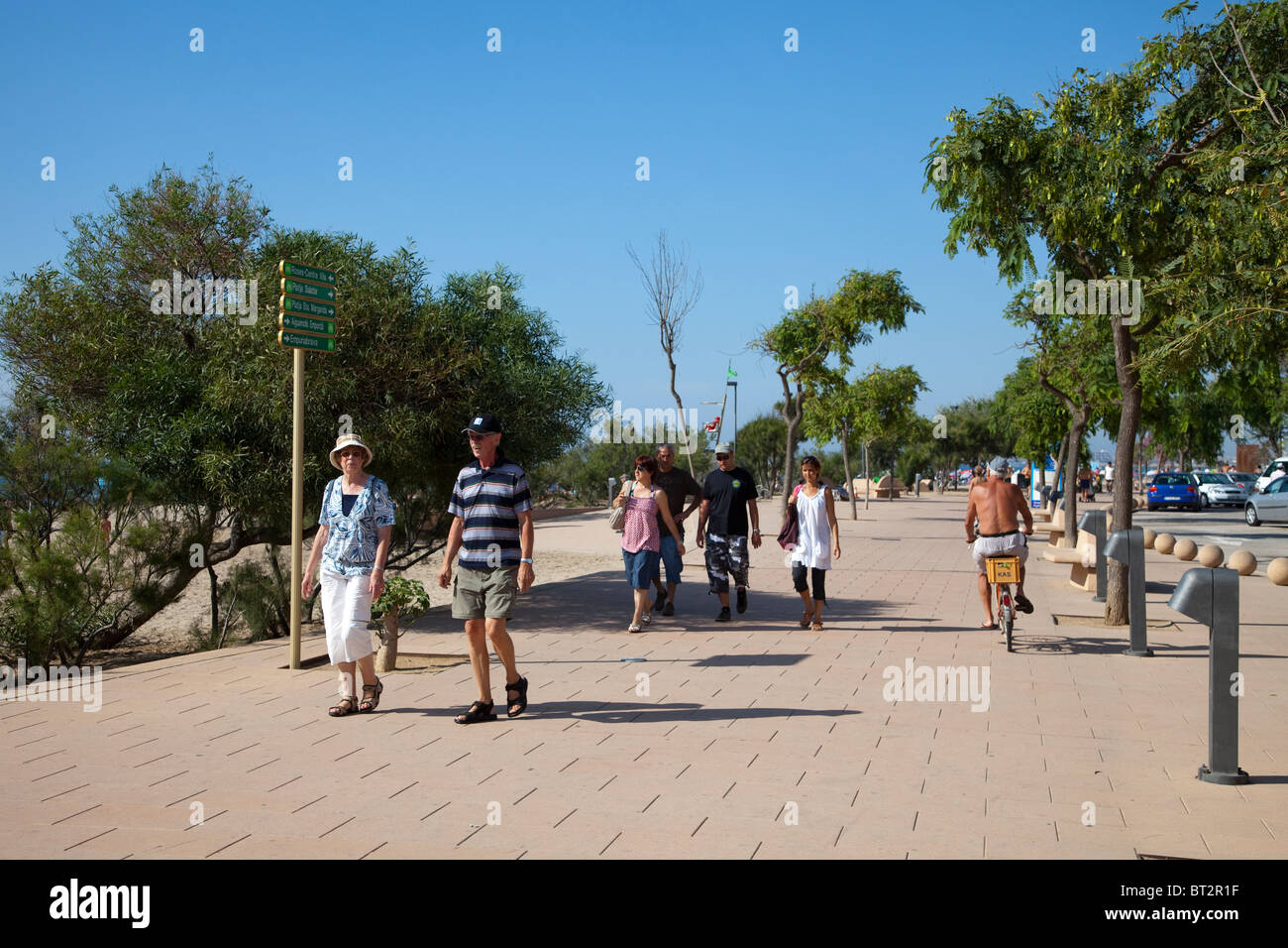 People walking and cycling on promenade at Roses Emporda Catalunya Spain Stock Photo
