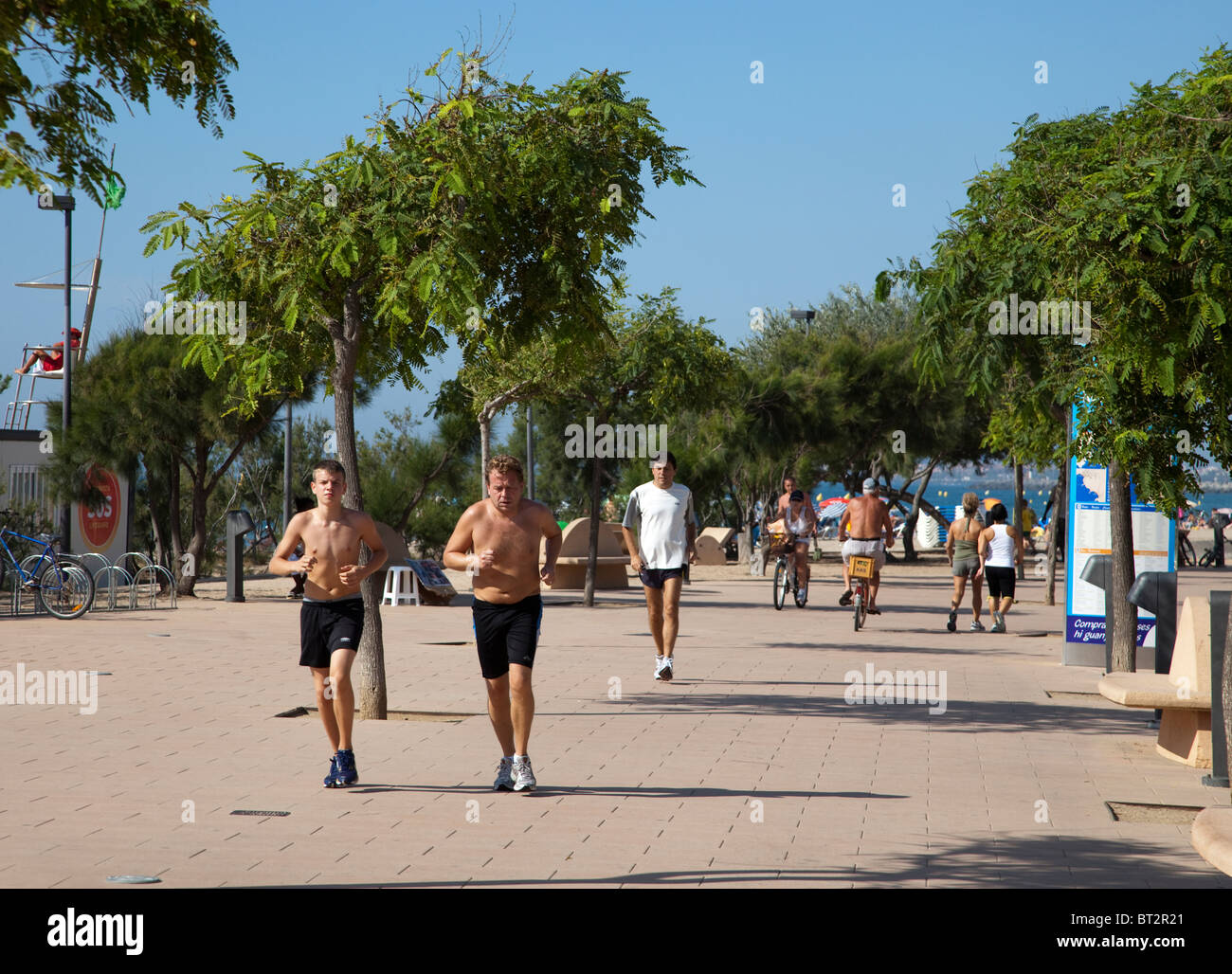 People running on promenade at Roses Emporda Catalunya Spain Stock Photo