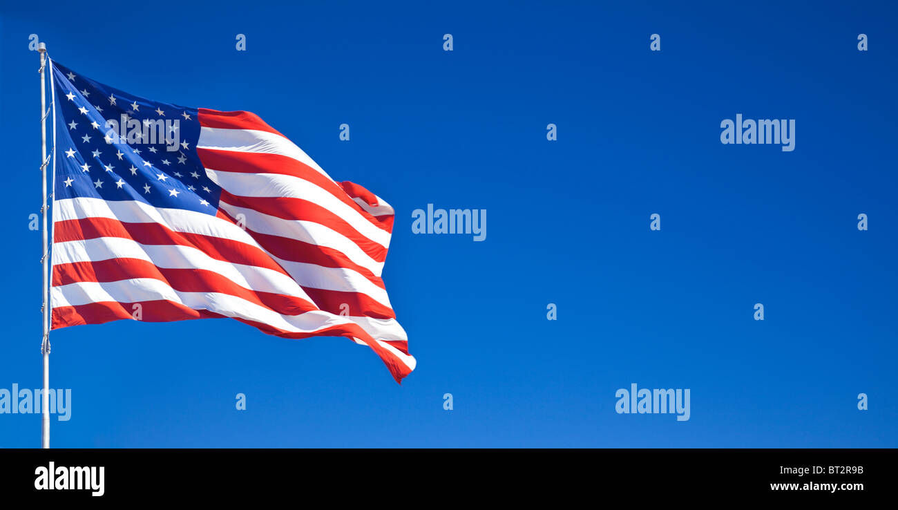 American flag fluttering in the blue sky Stock Photo