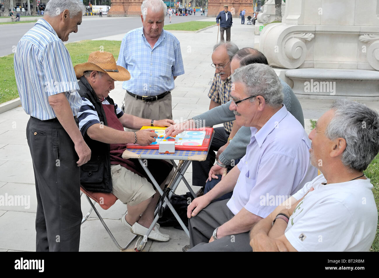 Retired men playing a board game Stock Photo
