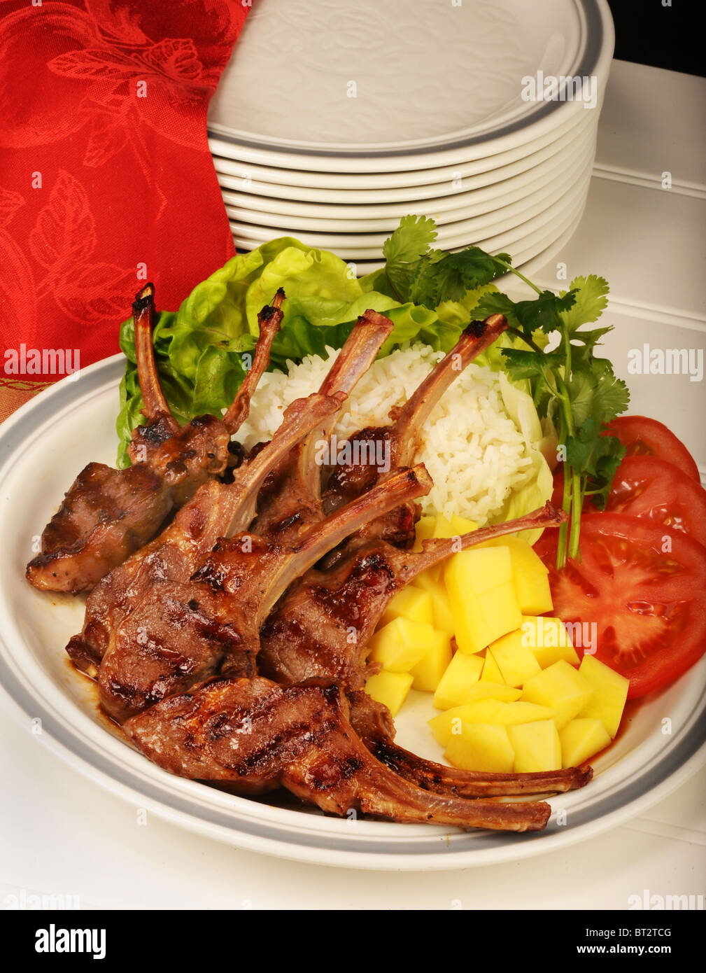 Roasted Lamb Chops with rice,tomatoes,and mango's Stock Photo Alamy