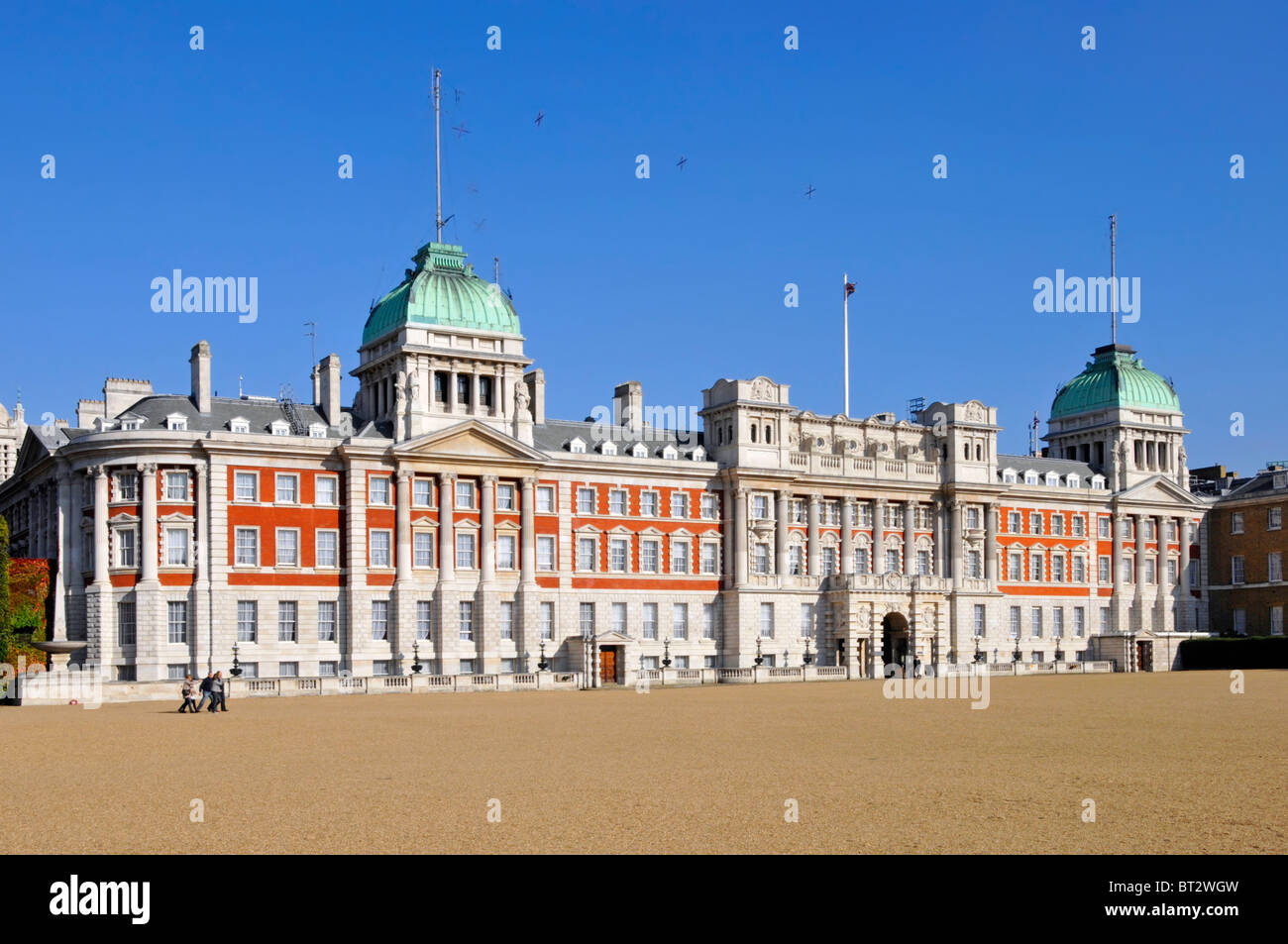 Admiralty Extension a red brick white stone building green roofs fronting the gravel Horse Guards Parade Ground  Westminster London England UK Stock Photo