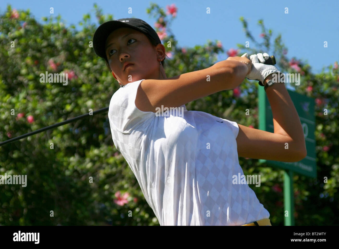 Fifteen year old Michelle Wie tees off during a practice round prior to The 2005 Sony Open In Hawaii. Stock Photo