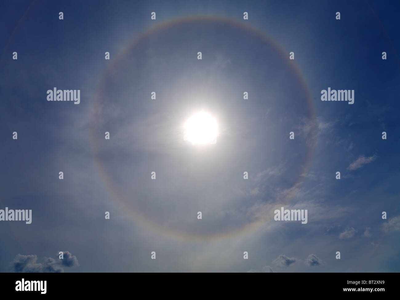 Circles halo in the blue sky around of the sun Stock Photo