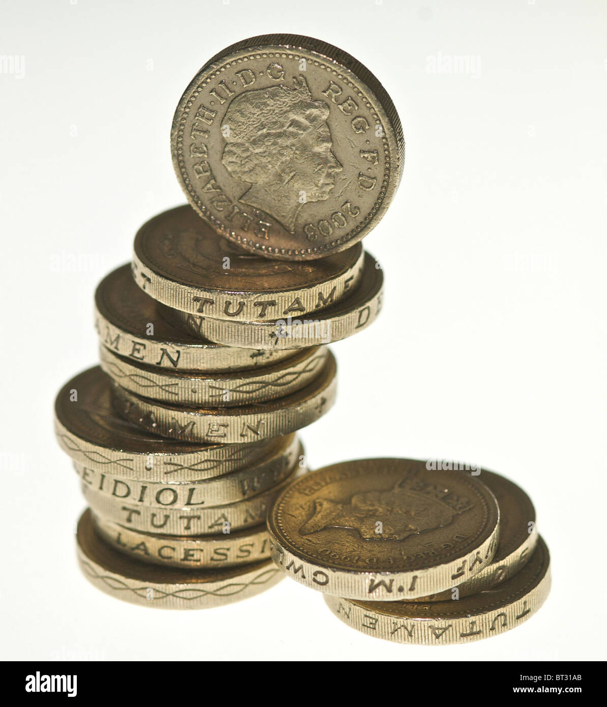 A pile of pound coins balanced Stock Photo - Alamy