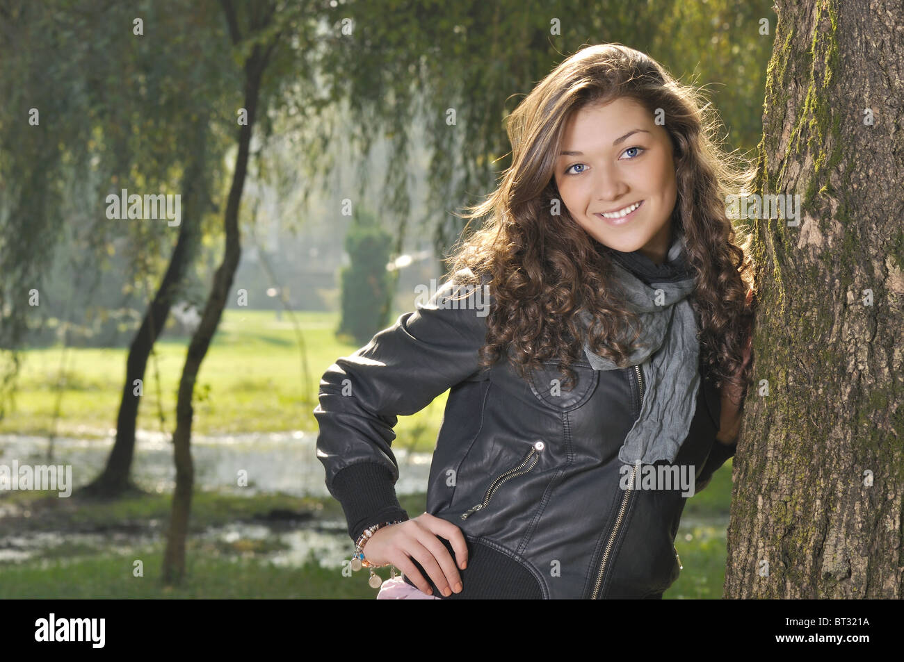 beautiful young woman with long curly hair in nature Stock Photo - Alamy