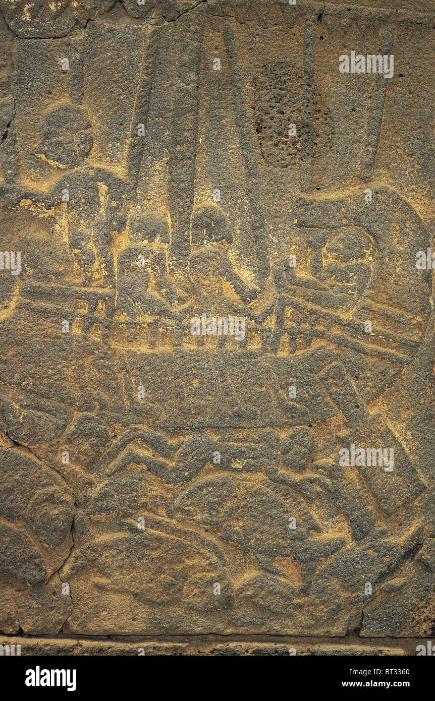 Hittite relief depicting a victory of a warship. Commander has a drink in his hand sitting in the bow. Corpses of enemy floating Stock Photo