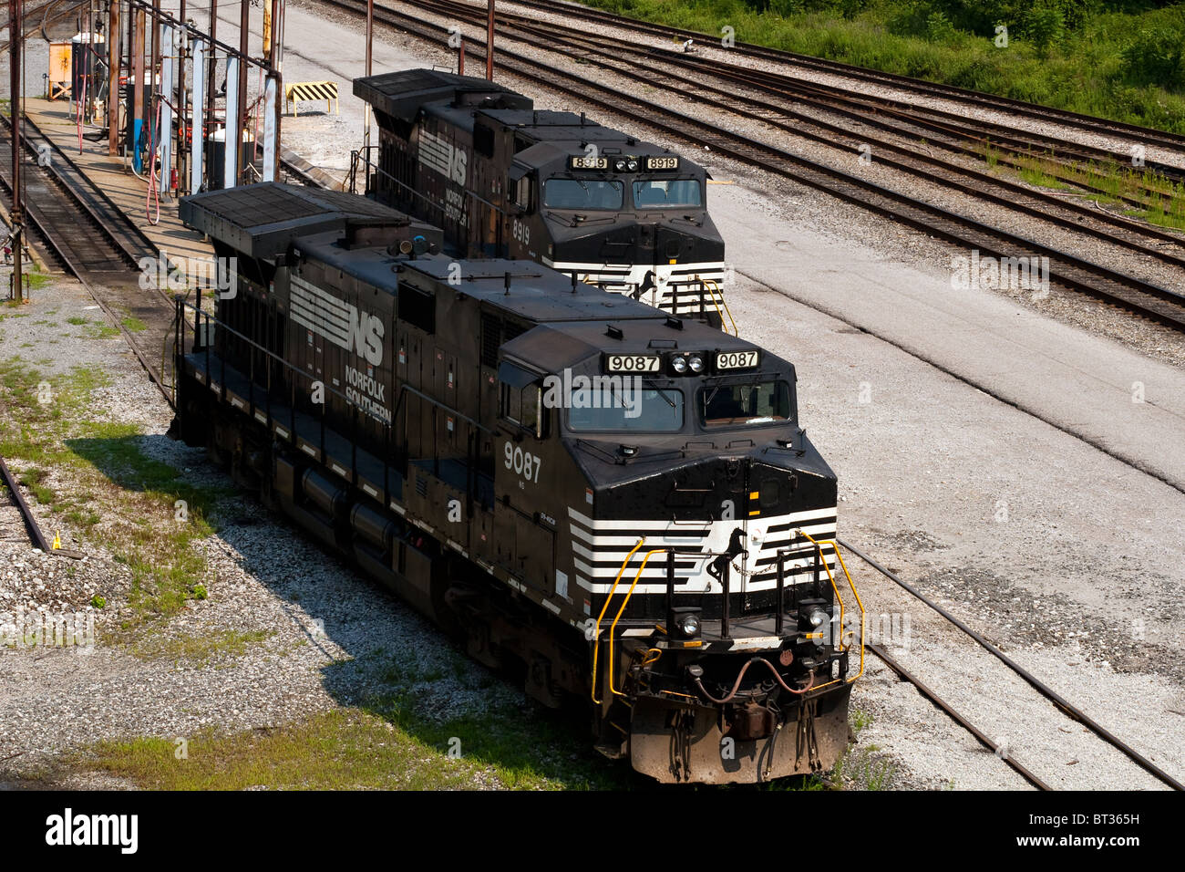 Two Norfolk Southern #9087 & #8919 GE D9-40CW locomotives (train engines) sit in the Dickinson, WV rail yard after refueling. Stock Photo