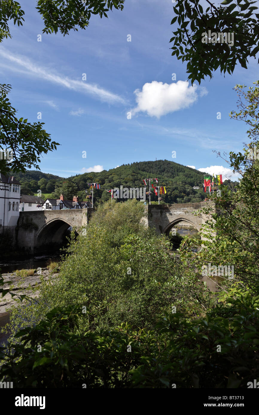 Llangollen road bridge decked out in flags on a beautiful early autumn day with the tree lined hilltop in the distance. Stock Photo