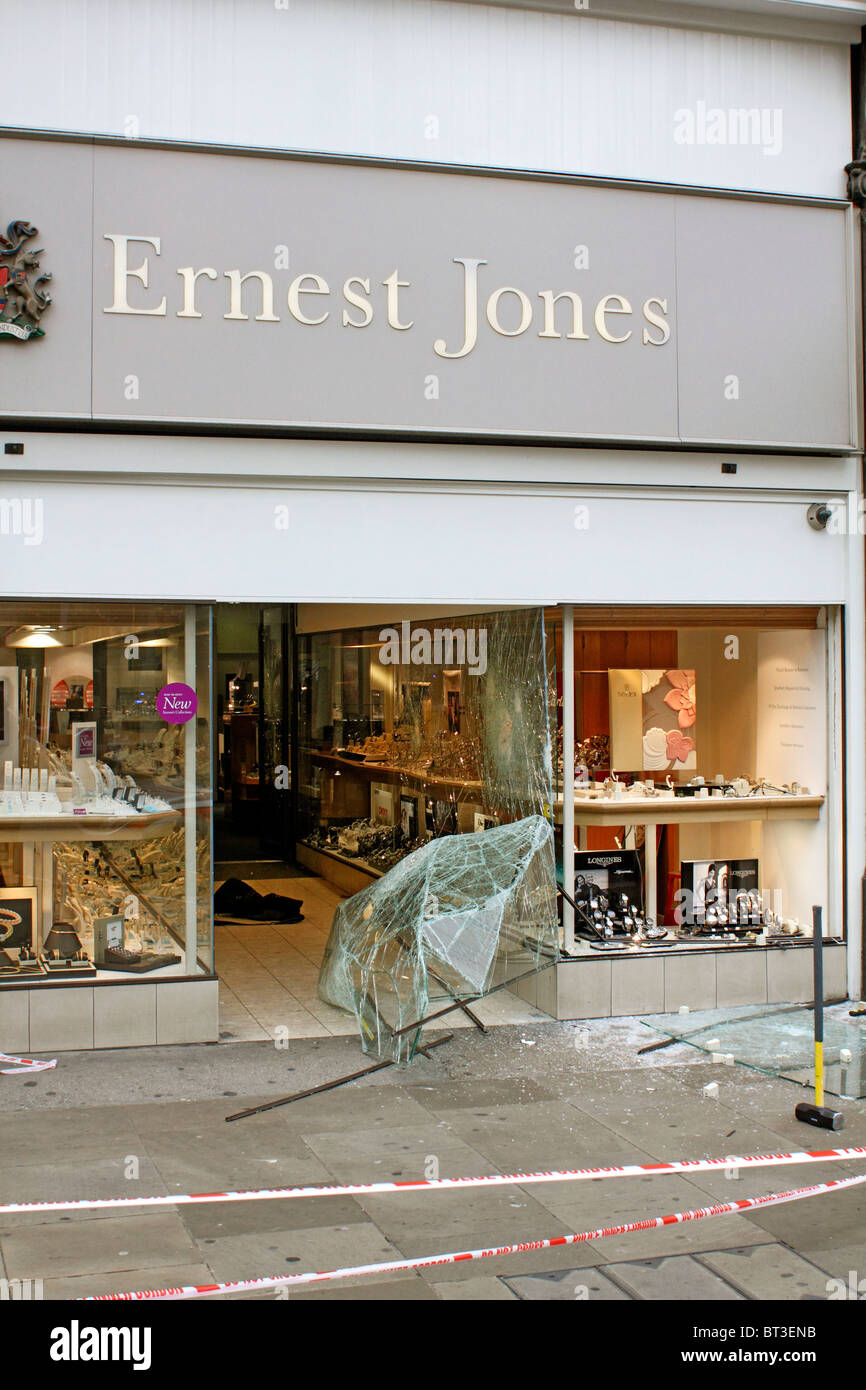 Window of high street jeweler is smashed out in a raid to steal watches from the window. Stock Photo